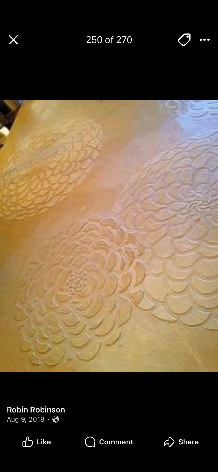 Hand-carved floral plaster relief in warm ochre